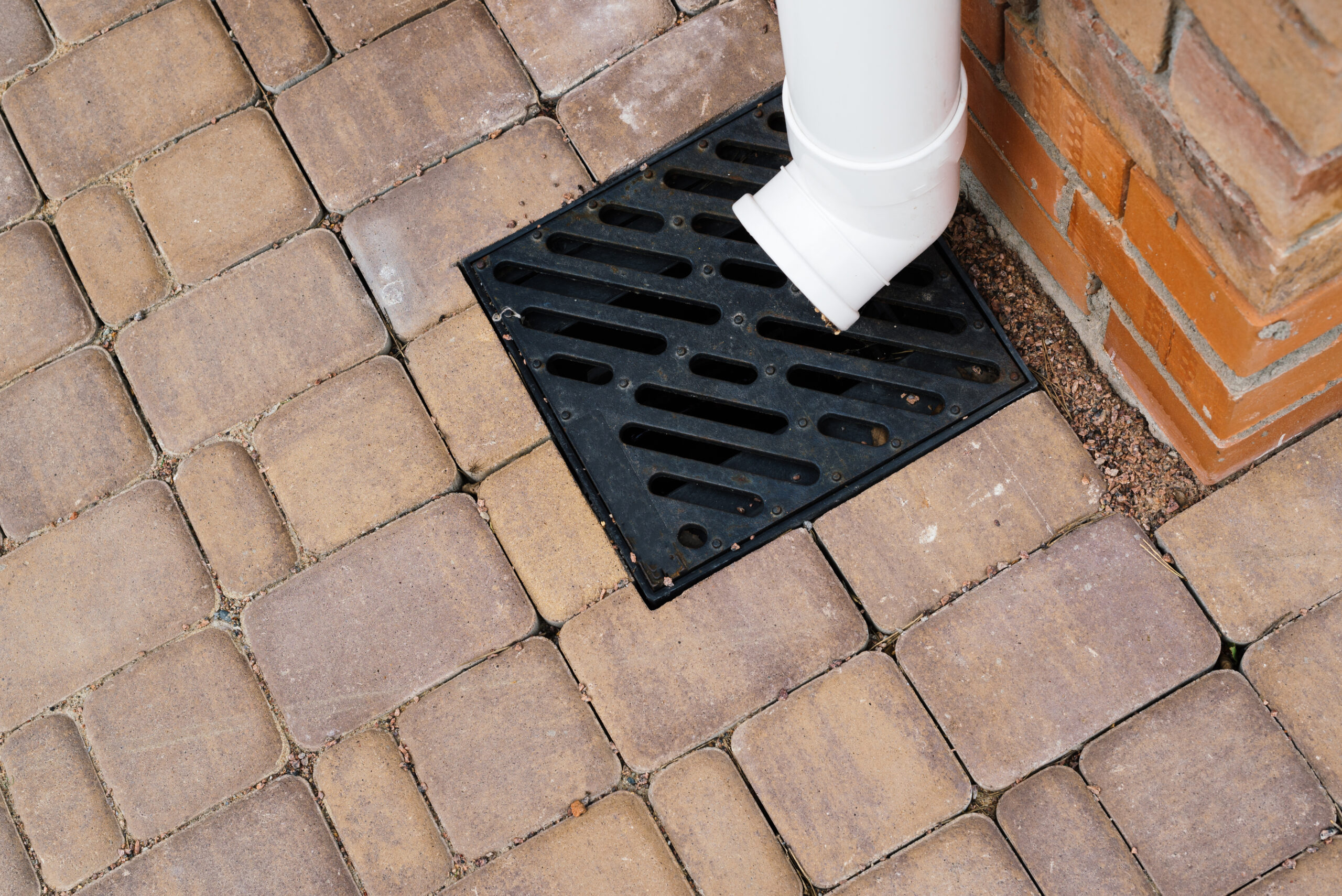 Stormwater cast iron drainage system in a pavement. Is used for drainage and separation of water from footpath.